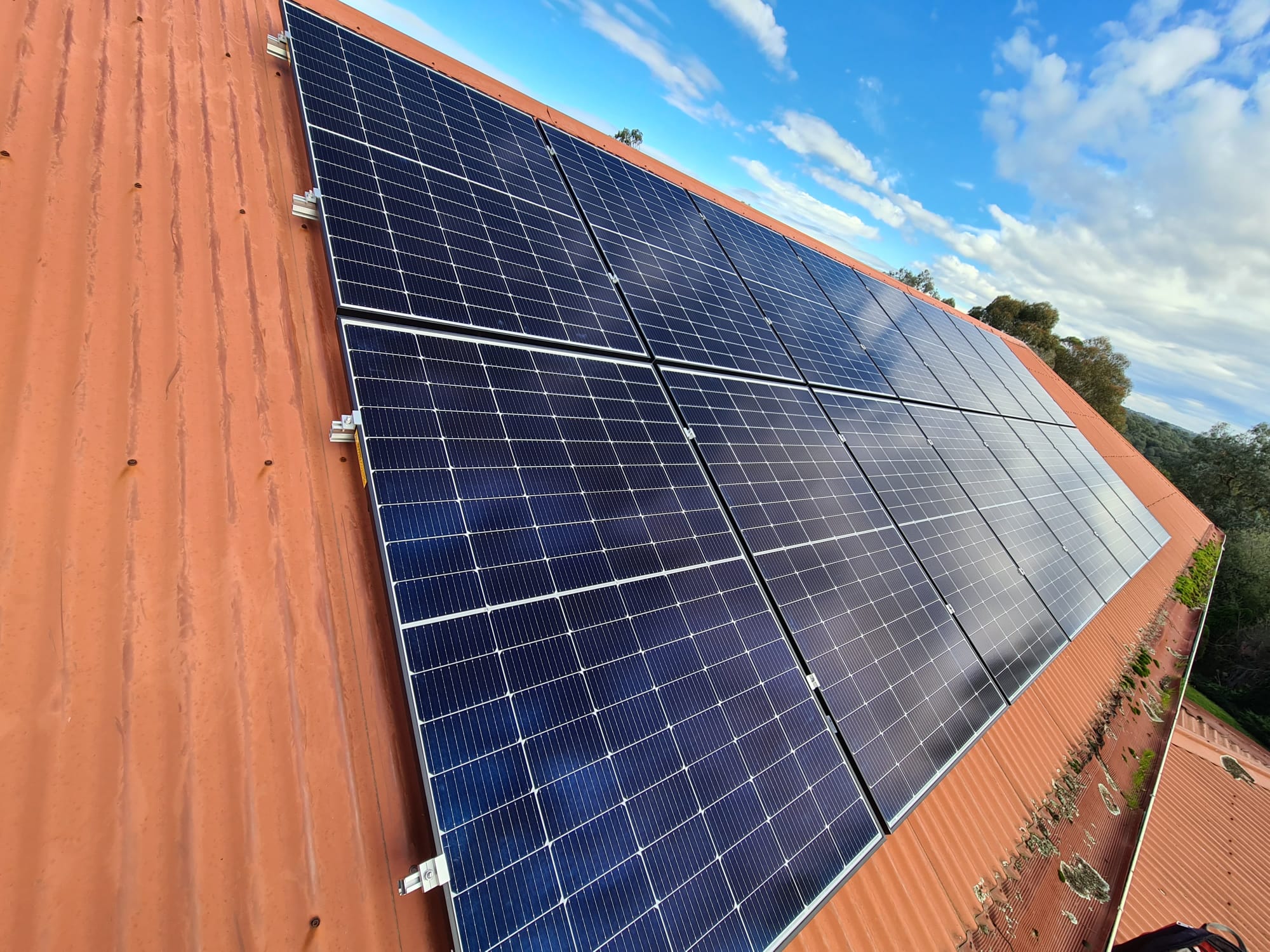 Solar panels on a red corrugated roof