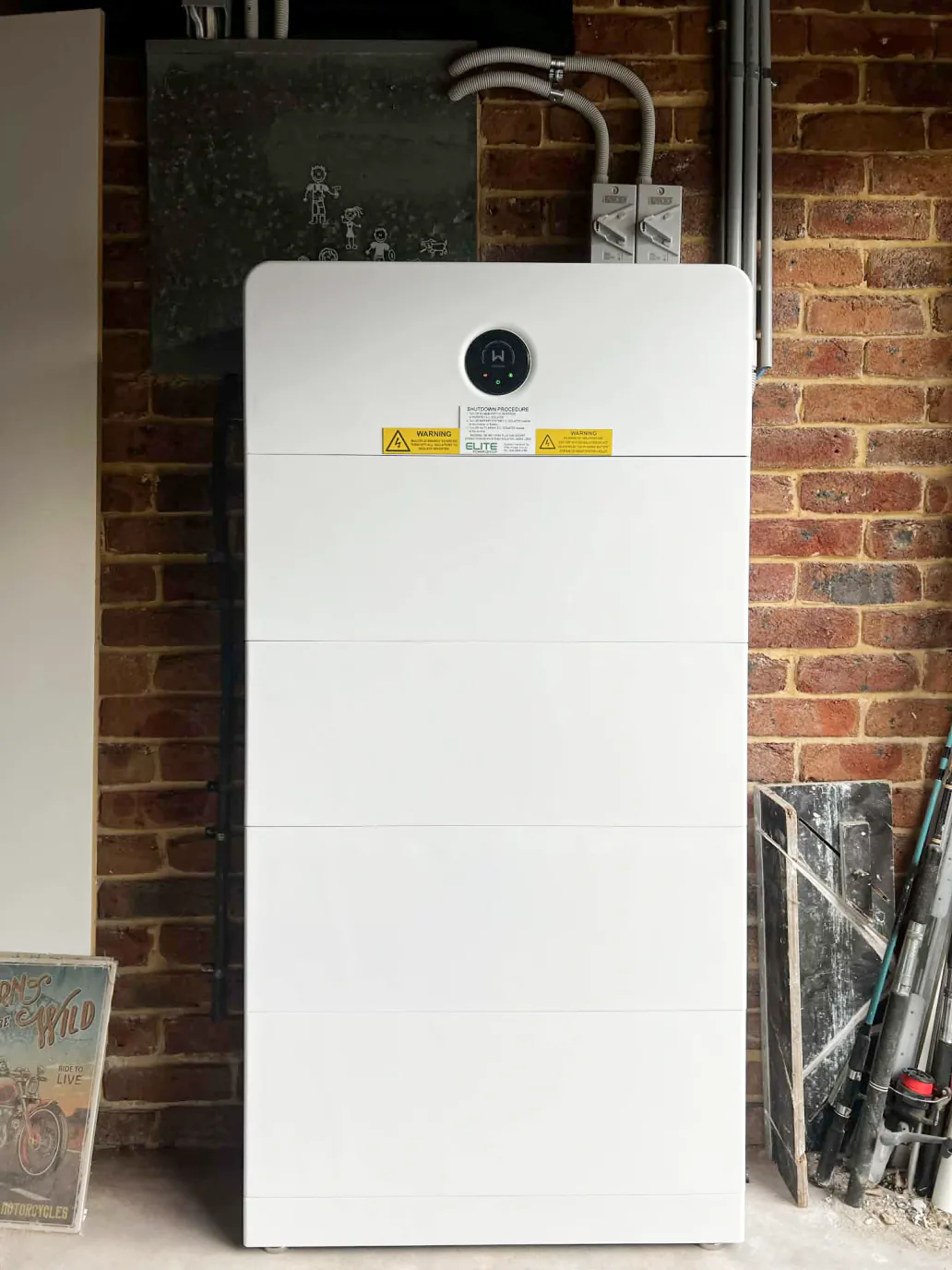 GoodWe battery installed against a brick wall